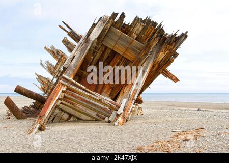 The remaining hull of the Pesuta shipwreck lying in sand north of Tlell River on East Beach in the Naikoon Provincial Park, Haida Gwaii, BC, Canada Stock Photo