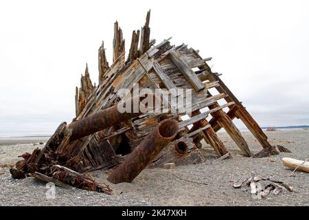 The remaining hull of the Pesuta shipwreck lying in sand north of Tlell River on East Beach in the Naikoon Provincial Park, Haida Gwaii, BC, Canada Stock Photo