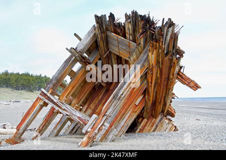 The remaining hull of the Pesuta shipwreck lying in sand north of Tlell River on East Beach in the Naikoon Provincial Park, Haida Gwaii, BC, Canada Stock Photo