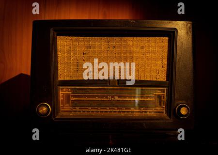 old 1950s retro Vintage fashioned radio with volume tuner knob and stereo receiver or speaker and dial button isolated in the stand Stock Photo