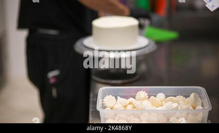 Closeup of white mini meringue swirls as food background Stock Photo