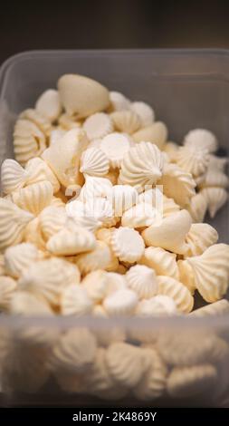 Closeup of white mini meringue swirls as food background Stock Photo