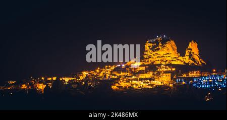 Panoramic landscape of Uchisar castle at night in Cappadocia, Central Anatolia, Turkey, Asia. Panoramic banner portion Stock Photo