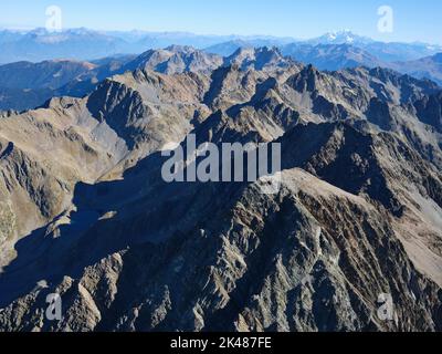 AERIAL VIEW. Large panorama of the Belledonne Massif with the Mont Blanc summit in the distance. Isère and Savoie, Auvergne-Rhône-Alpes, France. Stock Photo