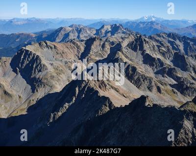 AERIAL VIEW. Large panorama of the Belledonne Massif with the Mont Blanc summit in the distance. Isère and Savoie, Auvergne-Rhône-Alpes, France. Stock Photo