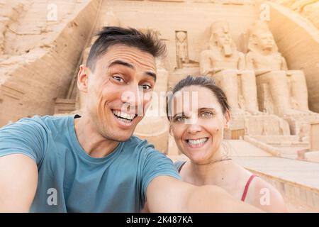 Tourist taking a selfie in front of an egyptian temple Stock Photo