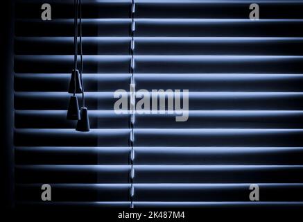 Aluminum horizontal blinds close-up against the backdrop of moonlight. Stock Photo