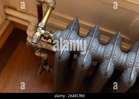 Wintage gray cast iron steam heating radiator, close-up Stock Photo