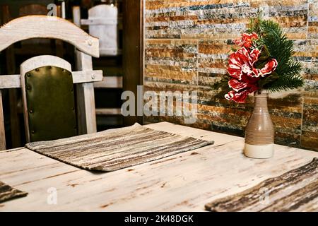 A table in a cafe ready for serving with a New Year's Christmas bouquet Stock Photo