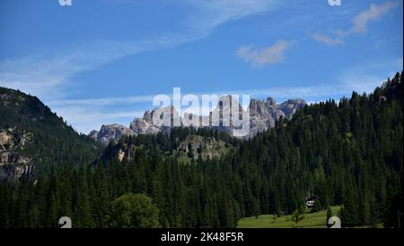 Dolomite peaks of the Tre Scarperi immersed in the forests, seen from Lake Misurina Stock Photo