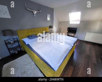 Kitzeck im Sausal, Austria - September 20, 2022: Guesthouse in the mountain village in Southern Styria, sleeping room decorated with old and new furni Stock Photo