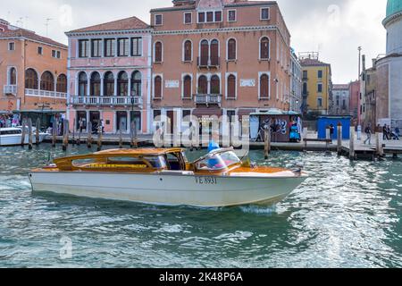 VENICE, ITALY - OCTOBER 12 : Water Taxi cruising along a canal in Venice on October 12, 2014. Unidentified people. Stock Photo