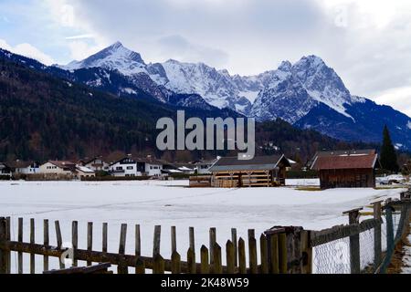 Alpine village Garmisch-Partenkirchen with the snowy Alps in the background in Bavaria on a cold day in March (Germany) Stock Photo