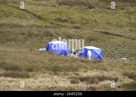 Forensic officers working on Saddleworth Moor, in north west England, where Greater Manchester Police are searching for the remains of the body of Keith Bennett. The 12-year-old was one of five victims of Ian Brady and Myra Hindley, with three of them later found buried on the moor. Picture date: Saturday October 1, 2022. Stock Photo