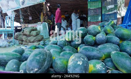 Bhinmal Rajasthan, India - May 23, 2017 : indian traditional rural village vegitable fruit market, Heap of Watermelon in foreground. Stock Photo