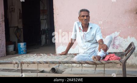 Bhinmal Rajasthan, India - May 18, 2017 : Indian Village old person resting on old cot bunk. Stock Photo