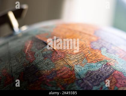 Ancient old globe map showing Ukraine, Kharkiv, Kiev and Dnipropetrovsk with selective focus. Stock Photo