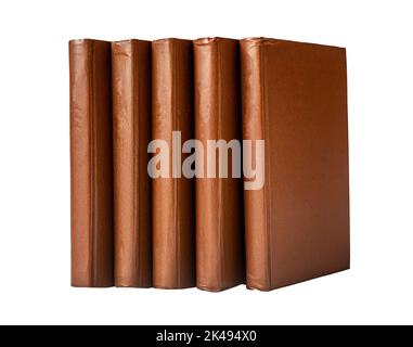 Brown classic books standing vertical with empty spines, templates isolated on white background. Stock Photo