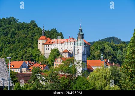 Town of Skofja Loka in Slovenia, townscape with castle and tower of St. Jacob Church, Upper Carniola region. Stock Photo