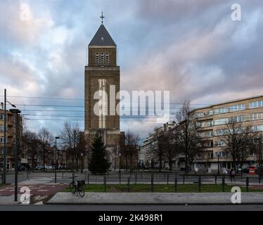 Jette, Brussels Capital Region, Belgium, 12 20 2020 - Our Lady of Lourdes church and rectangular tower at sunset Stock Photo