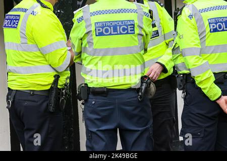Metropolitan Police officer back of the vest in London Stock Photo