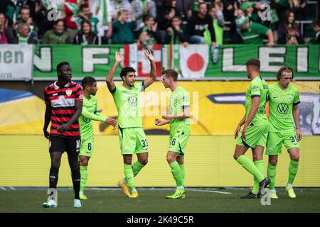 Wolfsburg, Germany. 01st Oct, 2022. Soccer: Bundesliga, VfL Wolfsburg - VfB Stuttgart, Matchday 8, Volkswagen Arena. Wolfsburg's Omar Marmoush (center) celebrates after scoring the equalizer to make it 1:1. Credit: Swen Pförtner/dpa - IMPORTANT NOTE: In accordance with the requirements of the DFL Deutsche Fußball Liga and the DFB Deutscher Fußball-Bund, it is prohibited to use or have used photographs taken in the stadium and/or of the match in the form of sequence pictures and/or video-like photo series./dpa/Alamy Live News Stock Photo