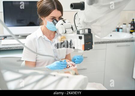 Dentist doing a comprehensive teeth cleaning to a patient Stock Photo