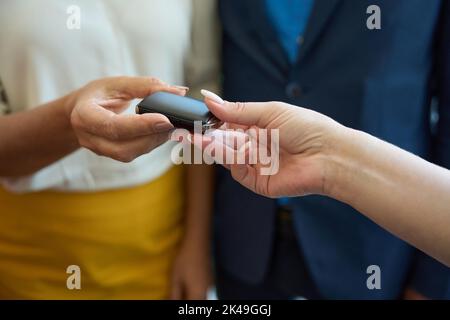 Process of handing over car key from hand to hand Stock Photo