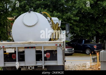 Septic truck in cleaning portable restroom Stock Photo