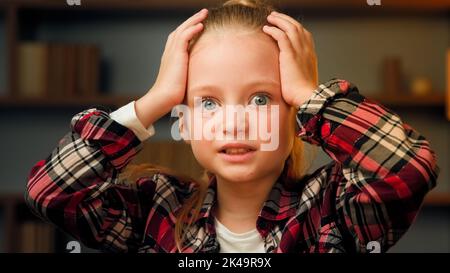 Scared young little girl shocked confused child feeling bullied abandoned alone caucasian blonde female kid preschool toddler six years old stressed Stock Photo