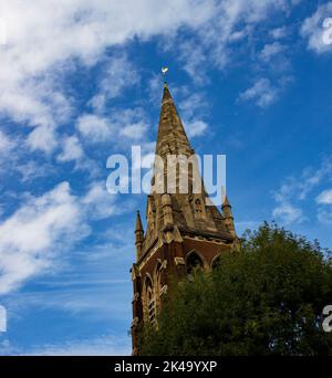 HTB (Holy Trinity Brompton) church spire in Courtfield Gardens, Kensington, London against blue sky Stock Photo