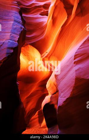 A vertical shot of the Antelope Canyon X in Arizona USA with colorful lights on the sandstones Stock Photo