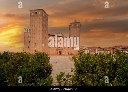 Fossano, Cuneo, Italy - October 01, 2022: The Castle of the Princes of Acaja (XIV century) in Castle square cobblestone with colorful sunset sky Stock Photo