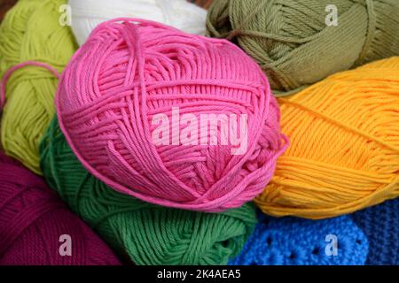 colorful skeins of wool, pink yellow and green Stock Photo