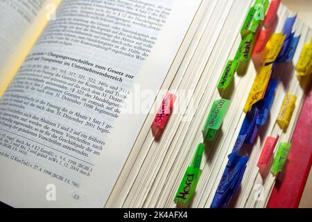 A closeup of an open law book with markers on the sides Stock Photo