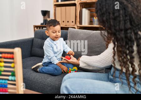 Mother and son having educational therapy at pedagogue center Stock Photo