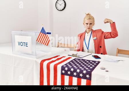 Beautiful caucasian woman working at political campaign strong person showing arm muscle, confident and proud of power Stock Photo