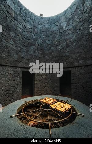 Tasty meat barbecued on volcanic heat, Timanfaya National Park, Canary Islands, Spain Stock Photo