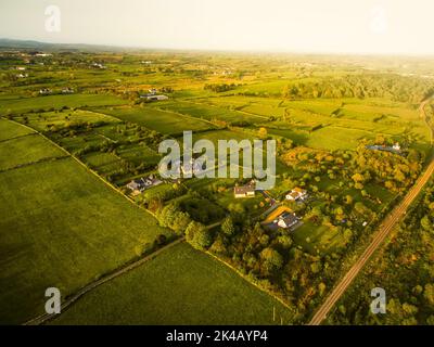 Houses in a rural village by Westport tow near the Irish Atlantic Coast.Greenery and real estate in Ireland concept. Agriculture and irish landscapes Stock Photo