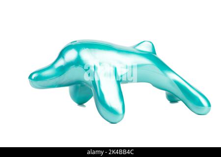 A stylized turquoise dolphin figurine. Isolated over white background. Close-up. Stock Photo