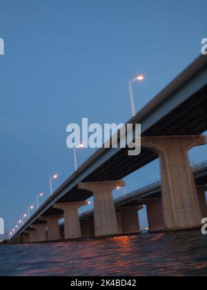 Late afternoon sunset over Barnegat Bay, New Jersey. The bridge is the Mathis Bridge carrying NJ State Highway 37 to and from Seaside Heights NJ Stock Photo