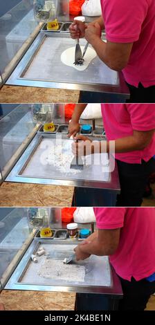 A step-by-step image of a food vendor making thai rolled ice cream on a frozen table top ice cream roll machine. Stock Photo