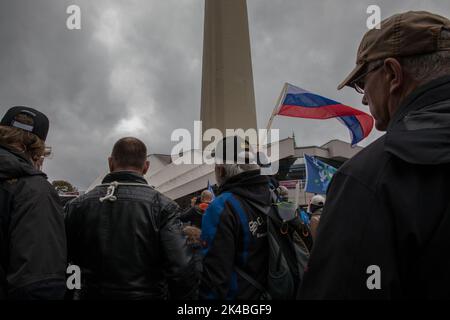 Berlin, Germany. 01st Oct, 2022. Protesters look towards a rally, which took place at the television tower in Berlin, on October 1, 2022. One protester held a Russian flag to show that he is against the current sanctions against Russia. Employees of craft companies, as well as right-wing extremist activists, gathered at the rally. They demanded an immediate end to sanctions against Russia, called the U.S. a warmonger, and called for withdrawal from NATO and the entire government's resignation. (Photo by Michael Kuenne/PRESSCOV/Sipa USA) Credit: Sipa USA/Alamy Live News Stock Photo