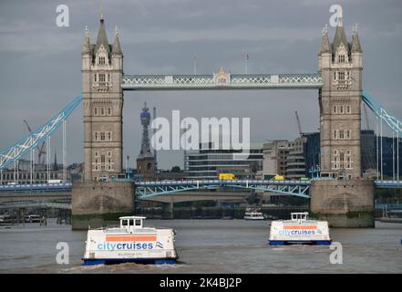 City Cruises' London sightseeing boats on the river Thames heading towards Tower Bridge in LondonM Stock Photo