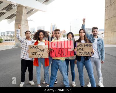 Group of multi-ethnic youth protests with posters in defense of the Earth. Activists protesting against pollution and global warming Stock Photo