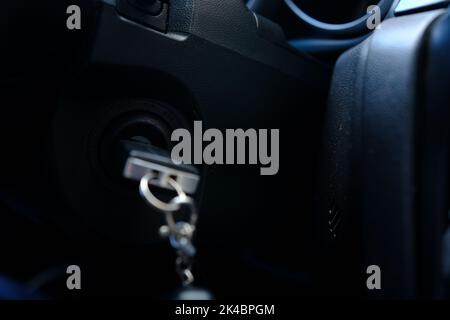 Ignition key of modern car close up. Car key in keyhole. Stock Photo