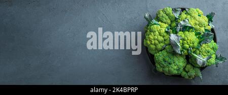 Broccoli in a black plate on a graphite background. Stock Photo
