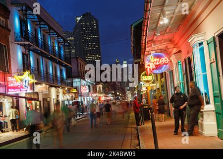 People browsing bars and clubs on Bourbon street in New Orleans at night. Stock Photo