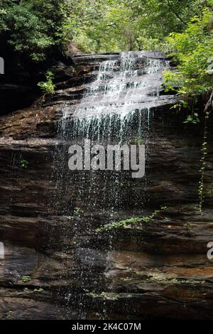 Moore Cove Falls, a lovely waterfall in western North Carolina that flows down over rock and falls 50 feet to the ground. Stock Photo