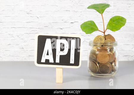 There is a piece of paper with a graph printed on it, a notebook, and an open vocabulary book on the desk. The word API is there. It's an acronym that Stock Photo